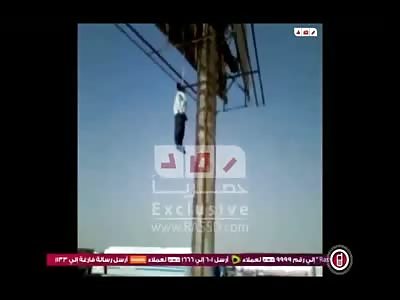 Man Hanging from Street Pole as Cars Beep at Him 
