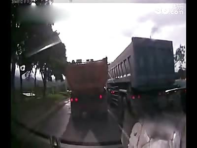Dash Cam Shows Tiny Car Sandwich Crushed between Two Large Trucks