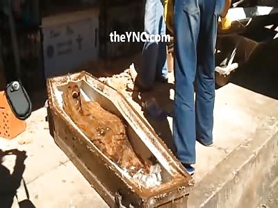 Skeleton of woman being exhumed.
