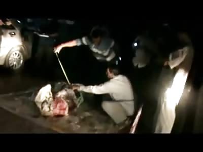 Executed Man Pulled from a Trunk ... Why are They Pouring Water on Him