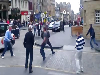 British football hooligans fight in the street 
