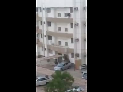 Suicidal Woman Jumps from Building on to Woman Getting into Car
