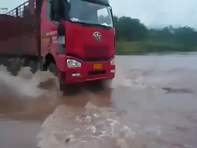 A truck driver drives his truck into flood water grave