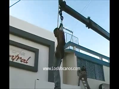 HUMAN PINATA: DEAD THIEF REMOVED BY CRANE FROM BUILDING