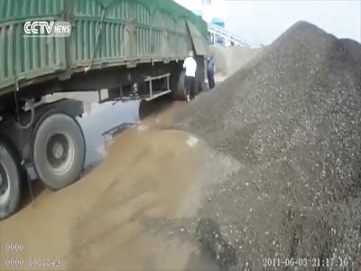 TRUCK DRIVER DUMPS TONS OF ROCK, SAND ON OFFICER INSPECTING HIS VEHICLE