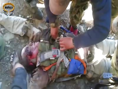 RUSSIAN PILOT'S BODY SURROUNDED BY REBELS