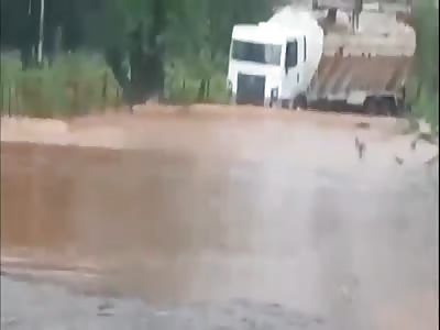 TRUCK CROSSING FLOODED ROAD FALLS OVER THREE PEDESTRIANS