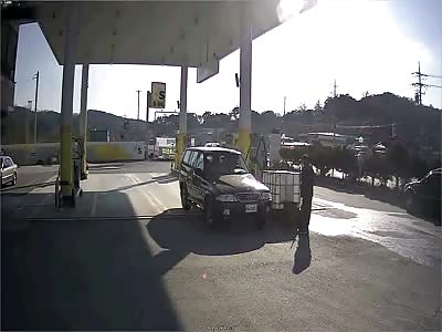 Car crashes and slides on its side through gas station