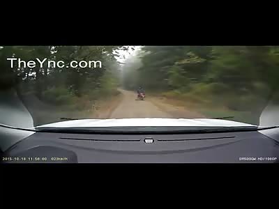 Motorcyclist Falls Under Police Car