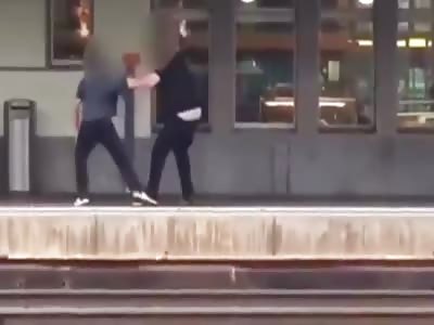  Guy falls on tracks while fight when train arrives  