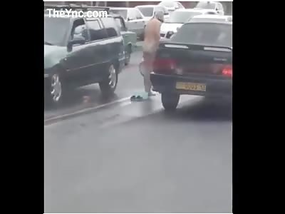 Woman Has A Wash In The Middle Of The Road. 