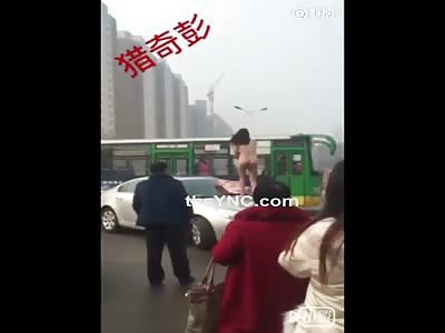 Naked woman jumps on hood to demand Justice.  