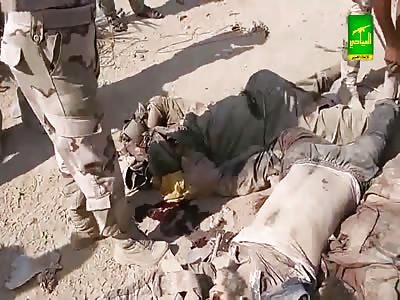 Dead ISIS terrorists are dragged away by Iraqi Citizen Soldiers occupying a Ute