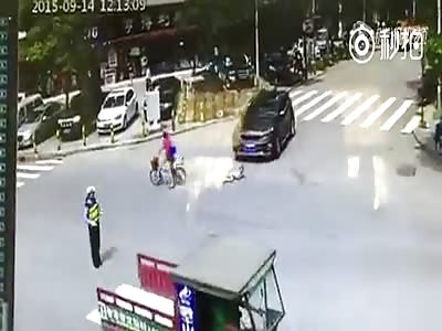 Child run over by car after falling off bike