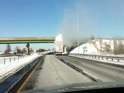Surplus Of Snow Explodes As Truck Passes Under Bridge