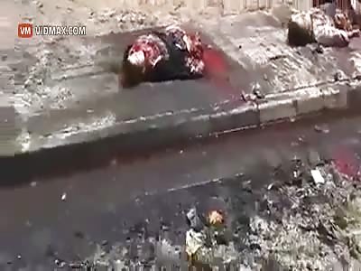 Mangled bodies litter the streets of Mosul, Iraq after a IED detonates in a marketplace