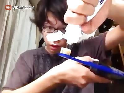Japanese kid attaches a toothbrush to an automatic pistol and attempts to brush his teeth