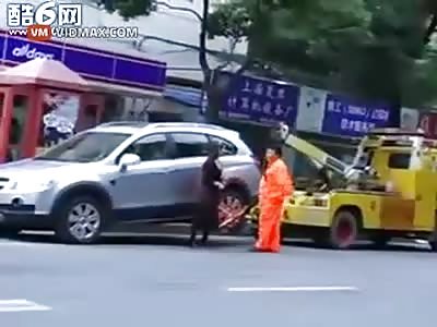 Chinese lady refuses a tow, takes the tow truck with her.