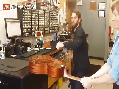 stupid idiot breaks his arm trying to smash a guitar