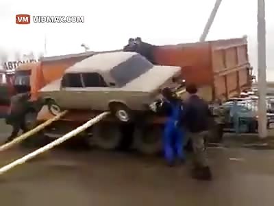EPIC FAIL! Russian's attempting to unload a car fail miserably, nearly crushed