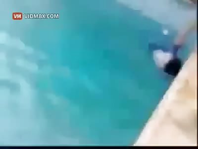 Arab parents teaching their kid to swim in a sick way.