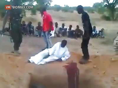Men in military uniform decapitate Boko Haram suspects. Nigeria.